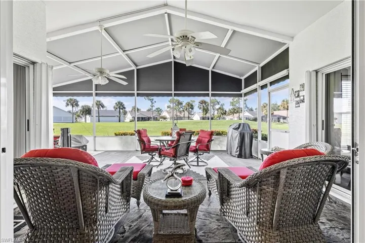 Sunroom featuring a residential view, ceiling fan, and a patio