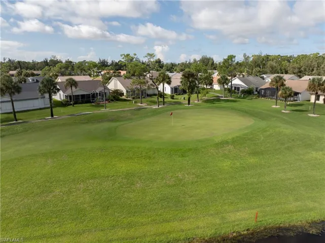 Surrounding community featuring a lawn, a residential view, and golf course view
