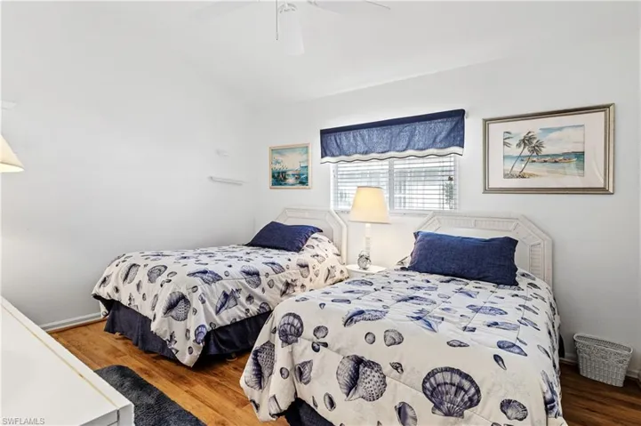 Bedroom with wood finished floors and a ceiling fan