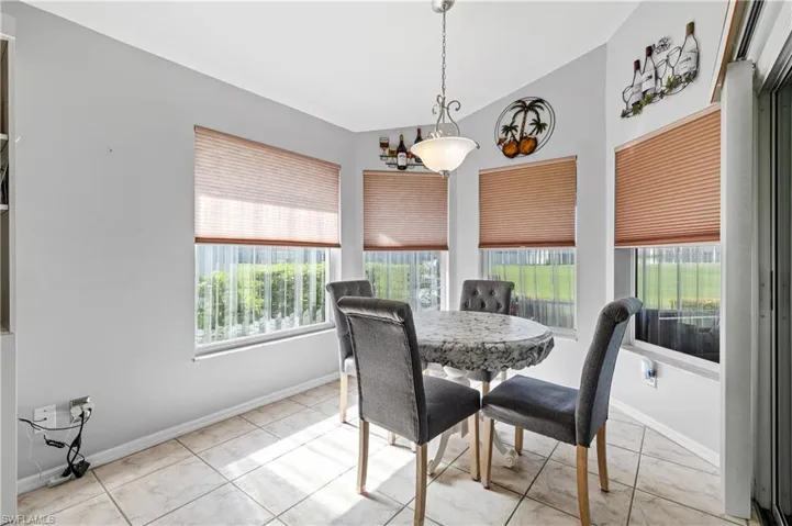 Dining room with healthy amount of natural light and light tile patterned floors