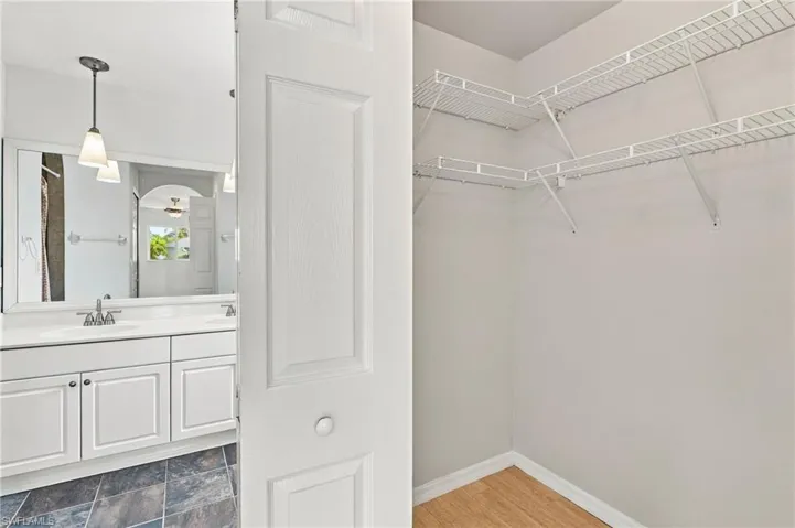 White bi-fold door opening to a closet with wire shelving
