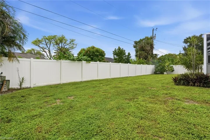 Expansive fenced yard with mature landscaping and established plantings