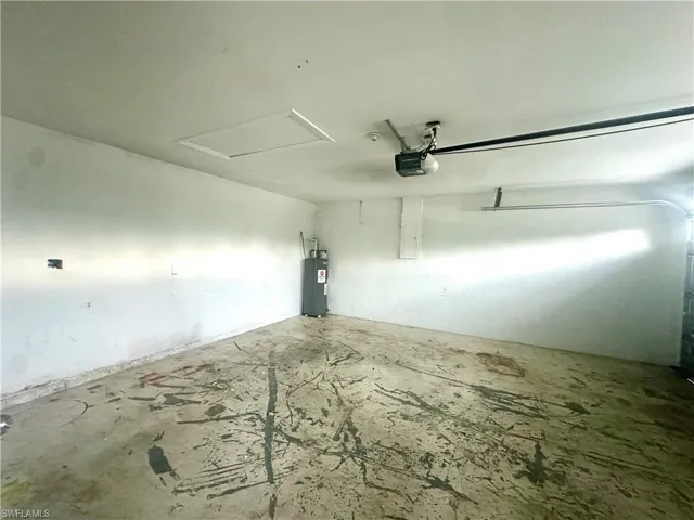 Garage with a garage door opener and electric water heater