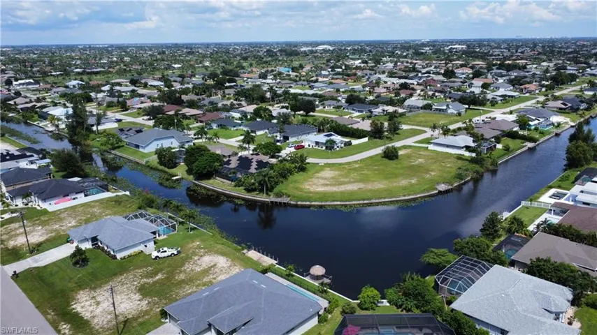 Birds eye view of property with a water view