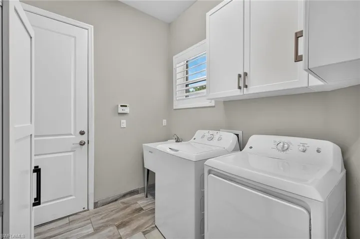 Built-in cabinets for additional storage, plantation shutters to match all other windows and a utility sink. What more could you ask for? BTW, you can't see to appreciate the tankless hw tank or the whole house generator!