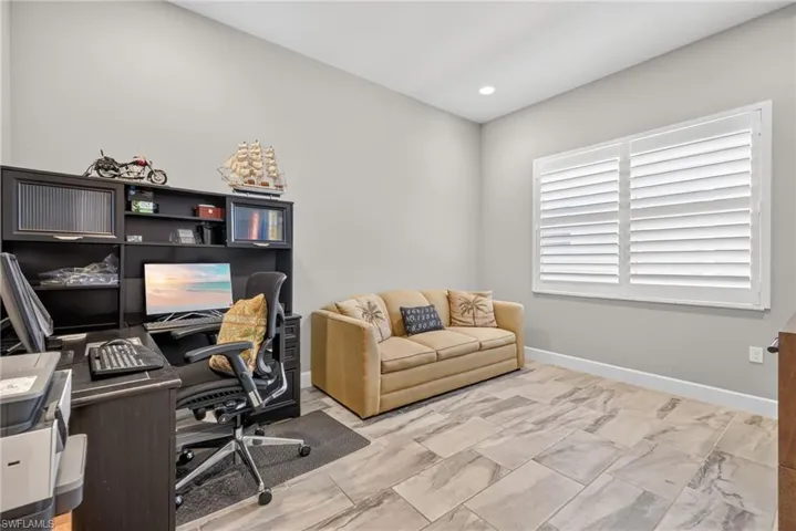 Den holds a sleeper sofa, corner desk and a tv console piece, too! Note the plantation shutters here, too!