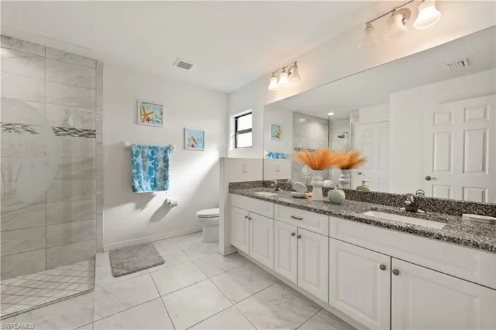 Bathroom with double vanity and a walk in shower