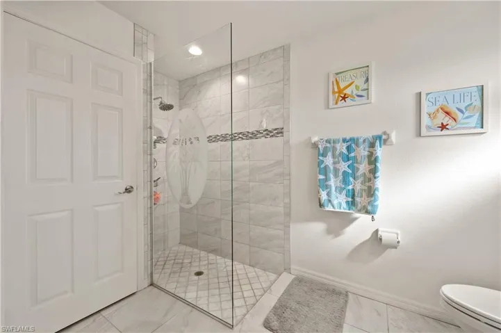 Bathroom featuring walk in shower and recessed lighting