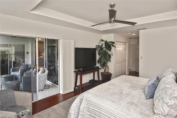 Bedroom featuring hardwood floors, a closet, and a ceiling fan