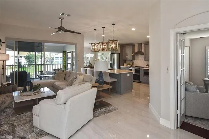 Living room with updated Porcelain  flooring, recessed lighting and a ceiling fan