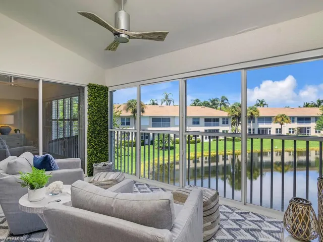 Sunroom / solarium featuring a water view, and Porcelain tile Staged