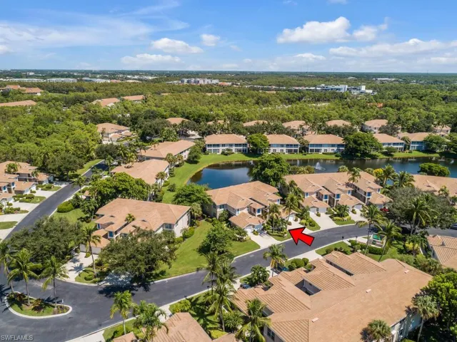Aerial view of property and surrounding area with a nearby body of water and nearby suburban area