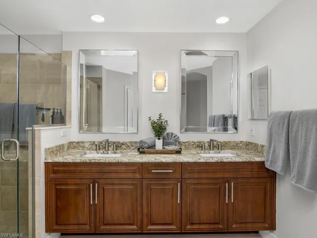 Master bath with a stall shower, double vanity, and recessed lighting