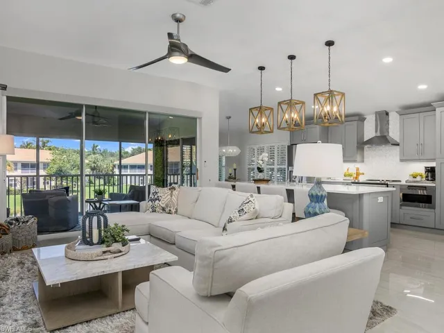 Living room with updated Porcelain flooring, recessed lighting, and a ceiling fan
