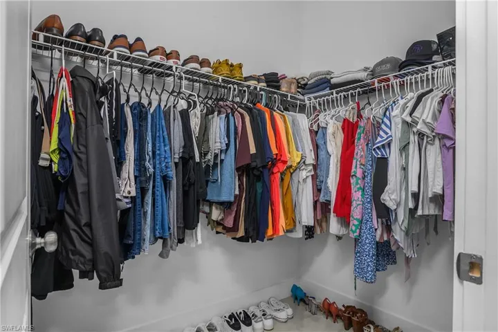 The property includes a walk-in closet with white wire shelving and hanging rods