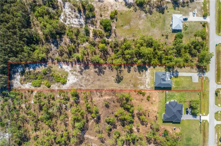 Expansive lot featuring a mix of cleared land and natural vegetation