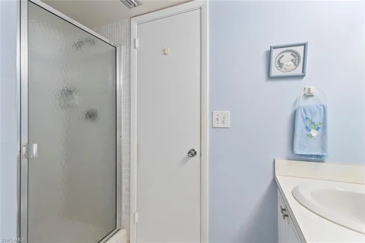 Bathroom featuring vanity and a shower stall