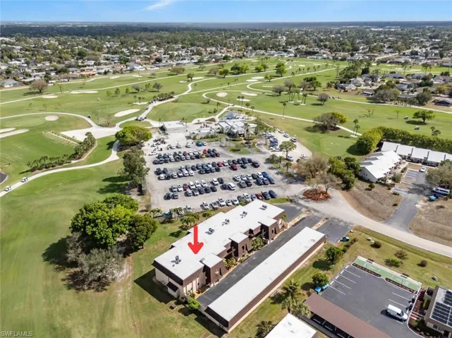 View of property location with a golf club and nearby suburban area
