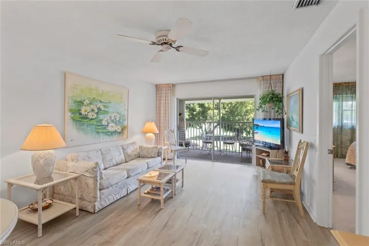 Living room with light wood-style floors and ceiling fan