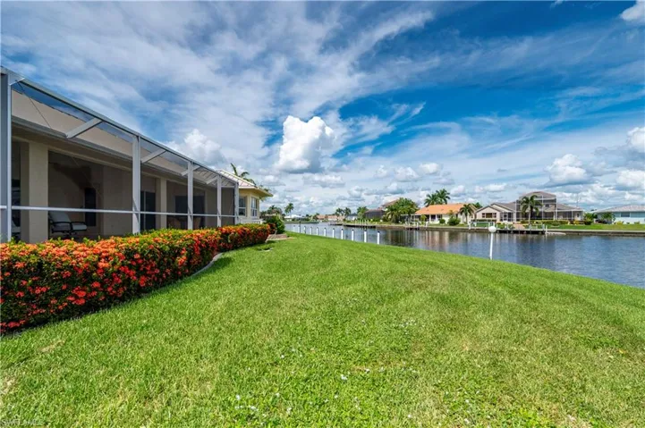 View of yard featuring a water view and a lanai