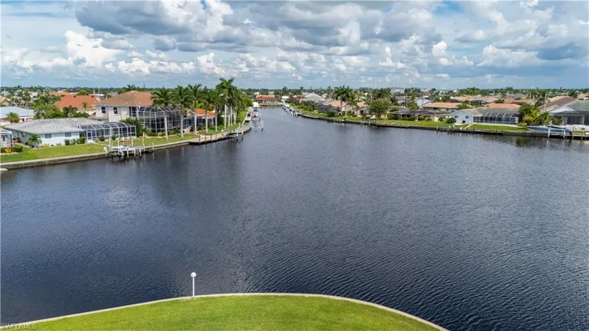 Birds eye view of property with a water view