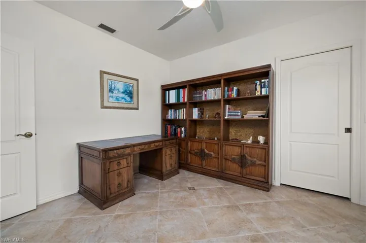Home office with ceiling fan and light tile patterned flooring
