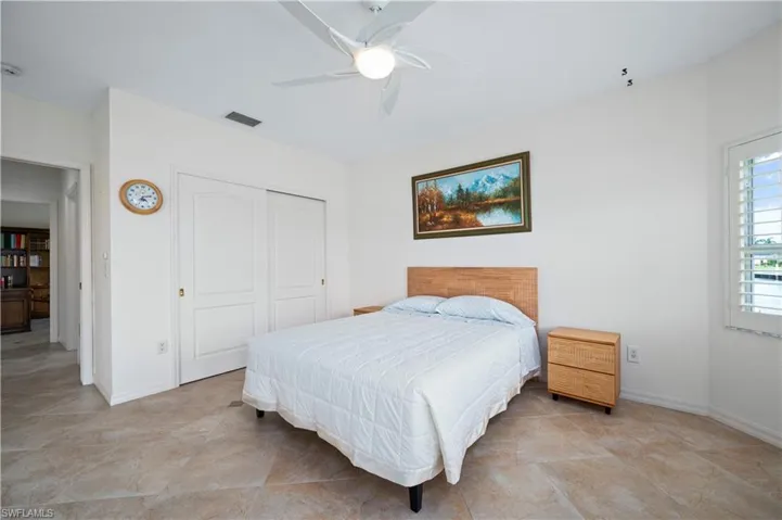 Bedroom featuring ceiling fan and a closet