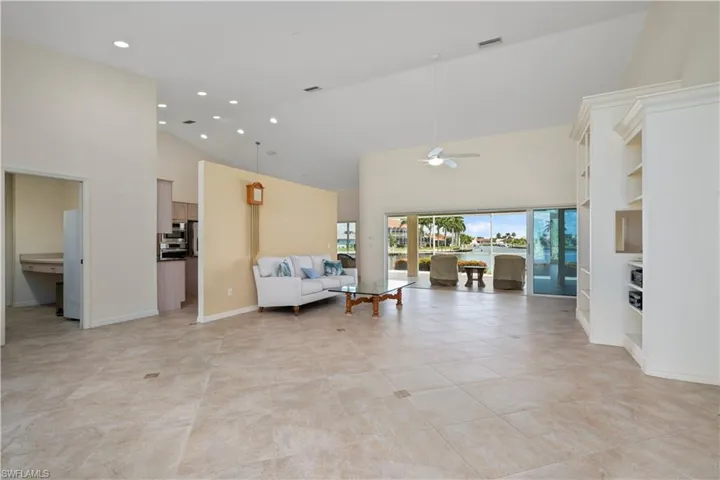 Living room featuring a towering ceiling and ceiling fan