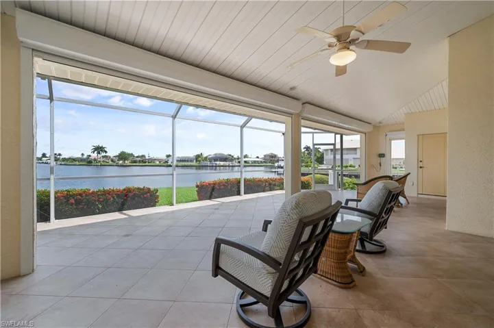 Sunroom featuring a water view, ceiling fan, and a wealth of natural light