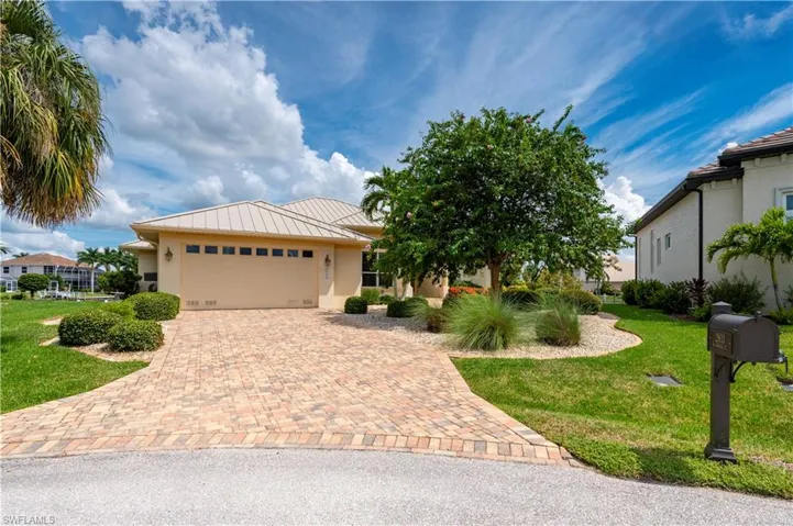 View of front of house featuring a front yard and a garage