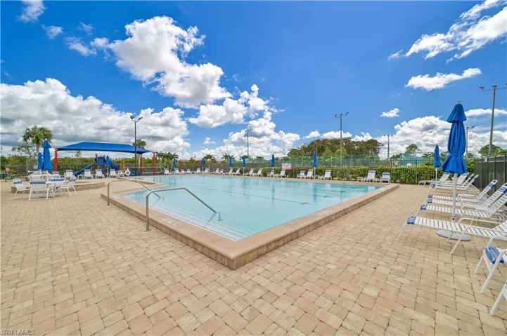 Community pool with fence and a patio area