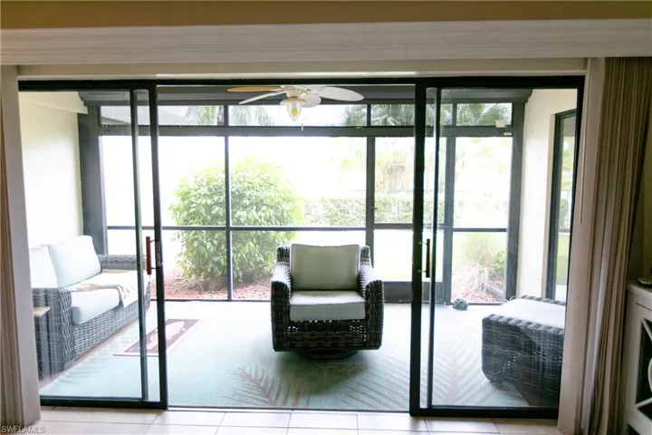 Entryway featuring plenty of natural light, tile patterned flooring, and a ceiling fan