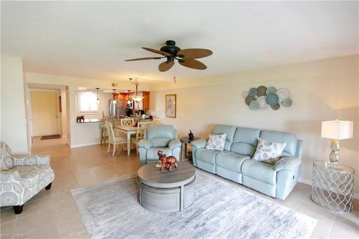 Living room featuring light tile patterned flooring and a ceiling fan