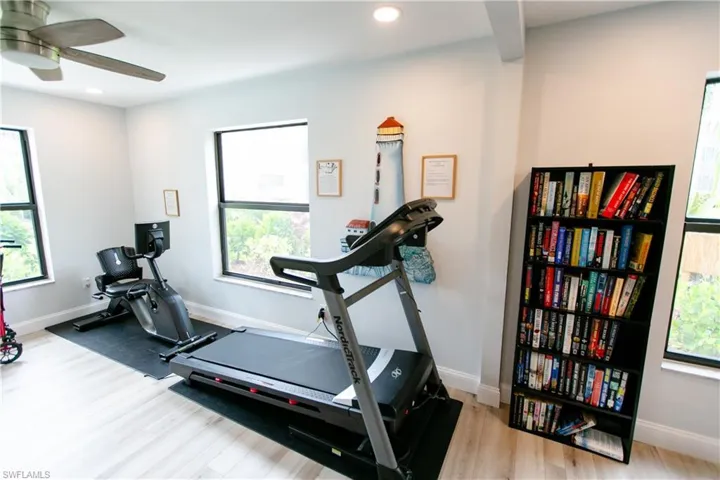 Exercise area featuring plenty of natural light, light wood-style floors, and recessed lighting