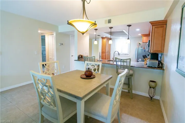 Dining room featuring light tile patterned floors and recessed lighting