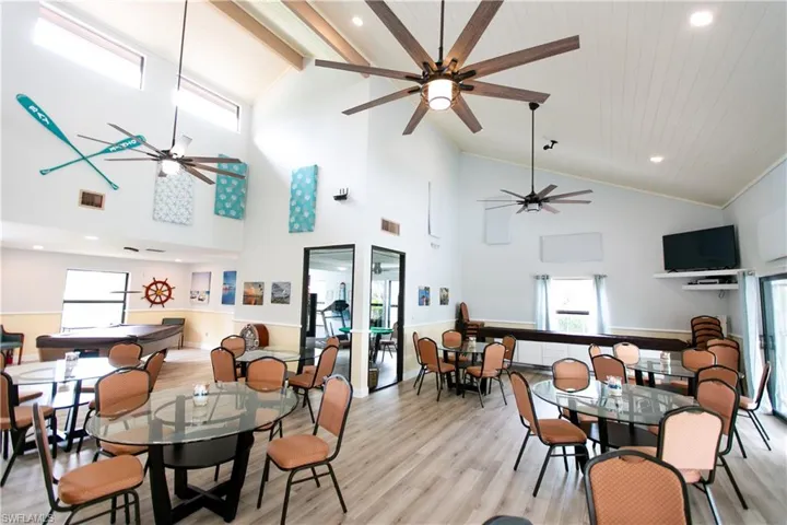 Dining room with healthy amount of natural light, light wood-style flooring, beamed ceiling, recessed lighting, and high vaulted ceiling