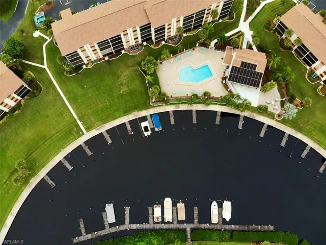 View of property location featuring a pool and a nearby body of water