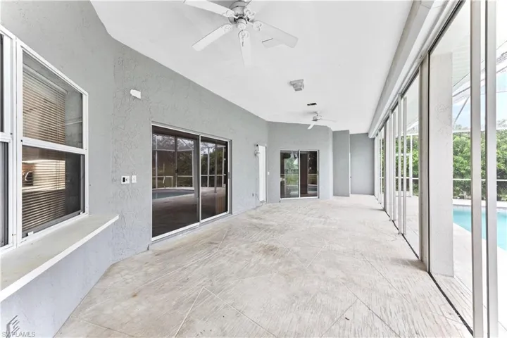 Unfurnished sunroom featuring ceiling fan
