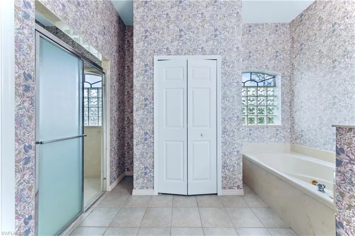 Bathroom with shower with separate bathtub, plenty of natural light, and tile patterned floors