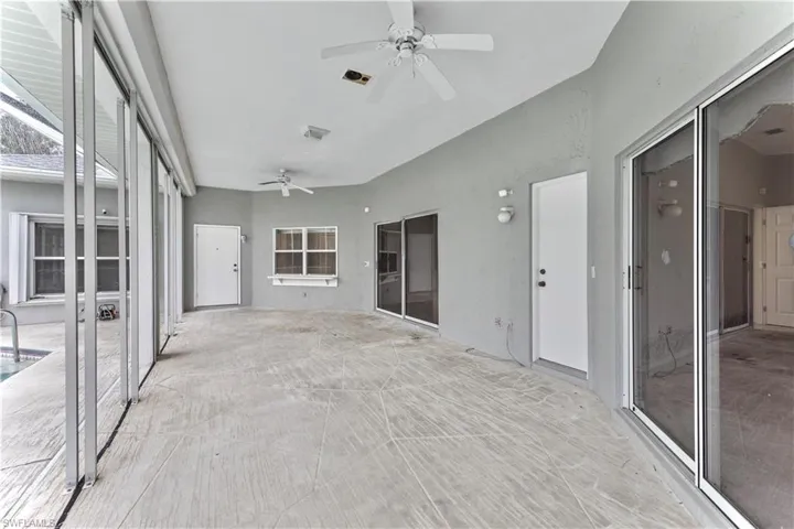Unfurnished sunroom with ceiling fan