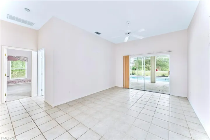 Unfurnished room with ceiling fan and light tile patterned flooring