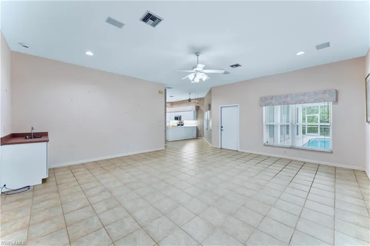 Unfurnished living room with ceiling fan