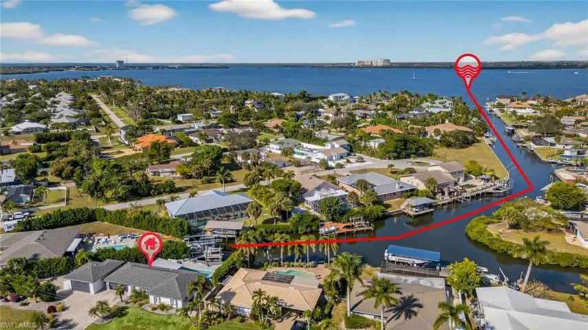 Aerial perspective of suburban area featuring a nearby body of water