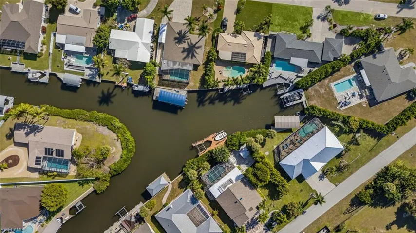 Aerial view of property's location featuring nearby suburban area and a nearby body of water