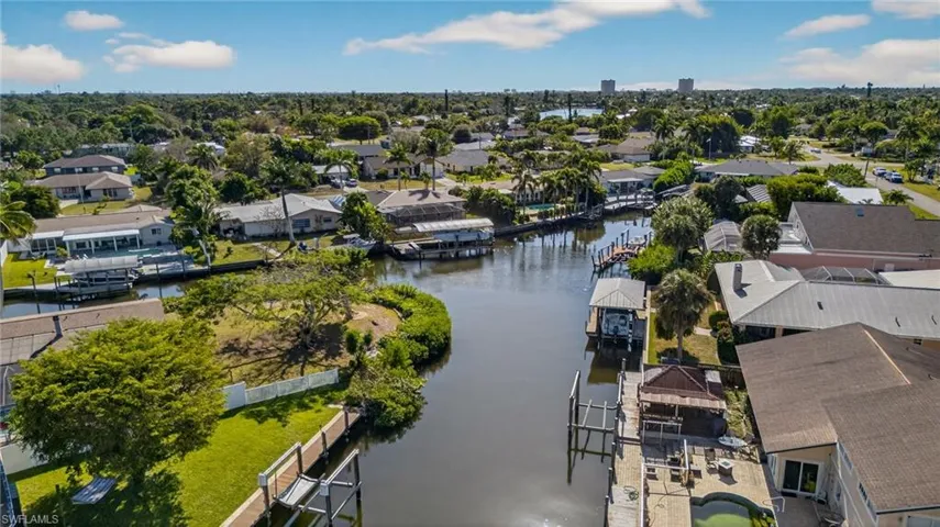 Aerial view of property's location with nearby suburban area and a nearby body of water