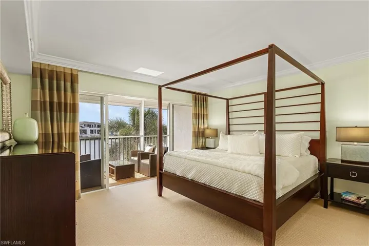 Bedroom featuring access to exterior, crown molding, and carpet