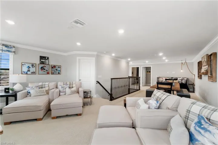 Living room with ornamental molding and carpet