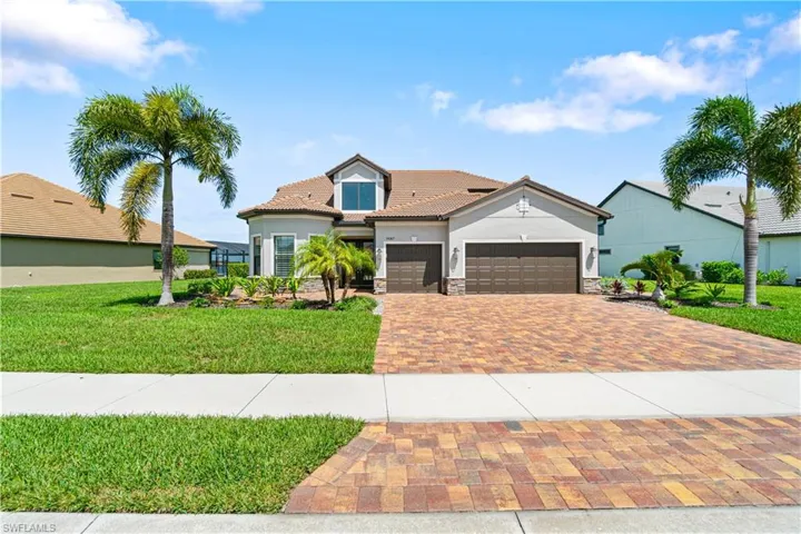 View of front of home featuring a garage and a front yard