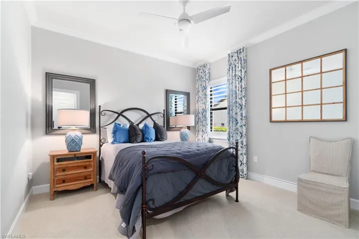 Bedroom with carpet, ceiling fan, and crown molding