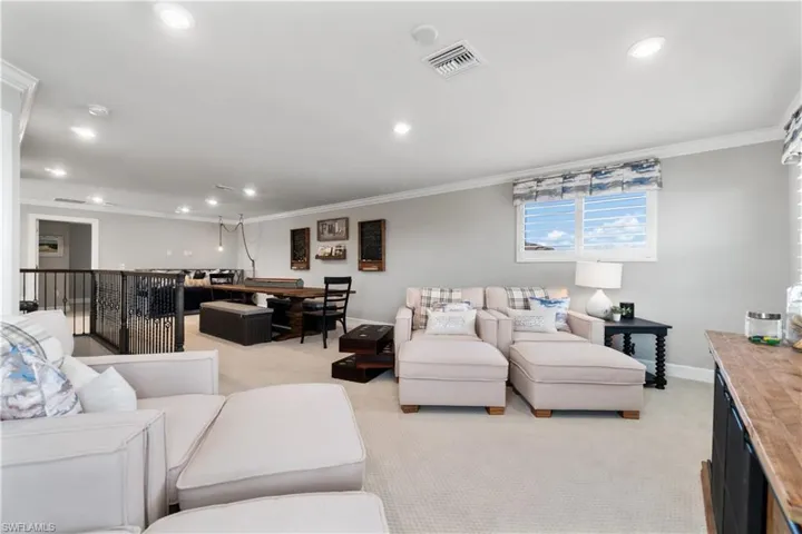 Living room featuring ornamental molding and light colored carpet